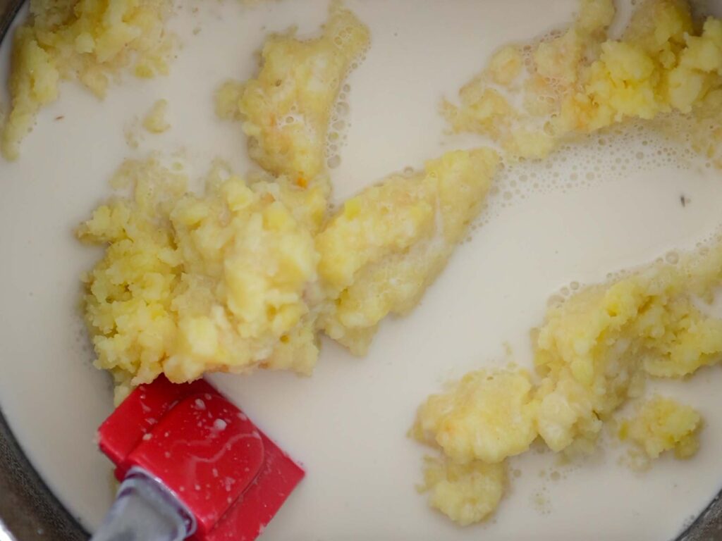 adding milk to potatoes